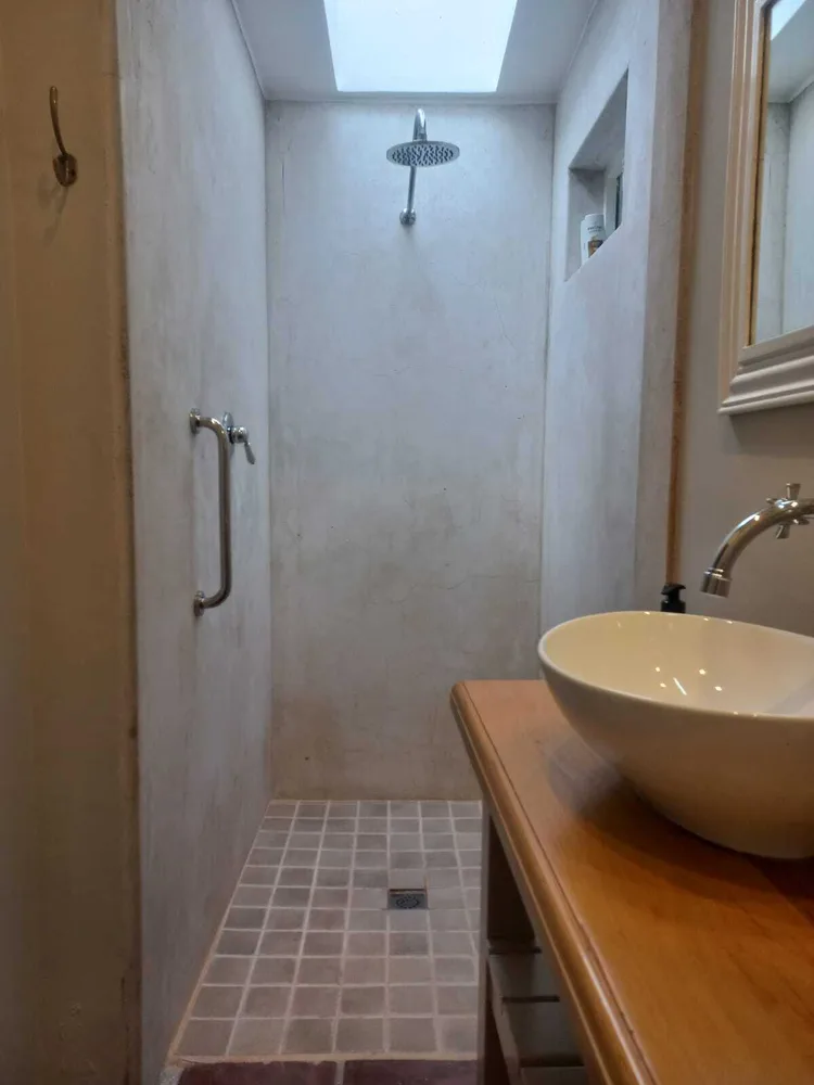 Walk-in shower with rainfall showerhead and tiled floor